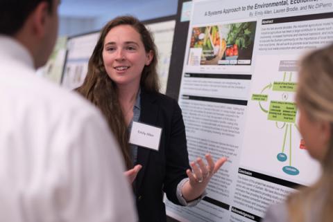 A female student presents her poster on local food