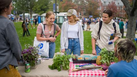 A thumbnail of two UNH students at a nutrition booth during UNH Day